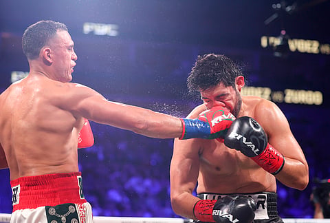 David Benavidez punches Gilberto Ramirez in a cruiserweight championship boxing match in Las Vegas. 