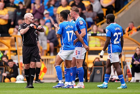 Sunderland players appeal to Referee Paul Tierney after he shows a red card to Sunderland's Daniel Ballard for pulling the hair of Wolverhampton Wanderers' Tolu Arokodare resulting in a red card during their English Premier League soccer match in Wolverhampton, England.