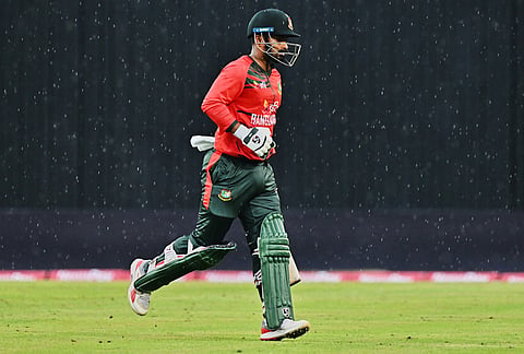 Bangladesh's Liton Das leaves the ground after rain stoped the play during the third T20 international cricket match between Bangladesh and New Zealand in Mirpur, Bangladesh.