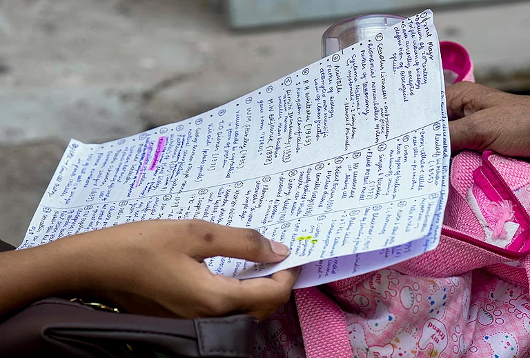 An aspirant revises from notes before appearing for the National Eligibility-cum-Entrance Test (NEET) UG-2026 examination, at Narela area, in New Delhi.
- | Photo: PTI/Shahbaz Khan