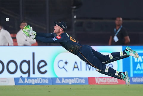 Gujarat Titans' Jos Buttler takes the catch to dismiss Punjab Kings' Cooper Connolly during the Indian Premier League cricket match between Punjab Kings and Gujarat Titans in Ahmedabad.