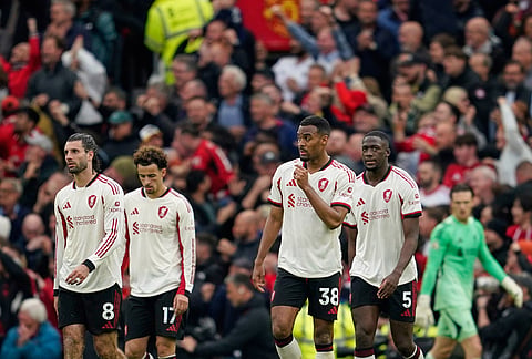 Liverpool players react after Manchester United's Kobbie Mainoo scored his side's third goal during the English Premier League soccer match between Manchester United and Liverpool in Manchester, England.