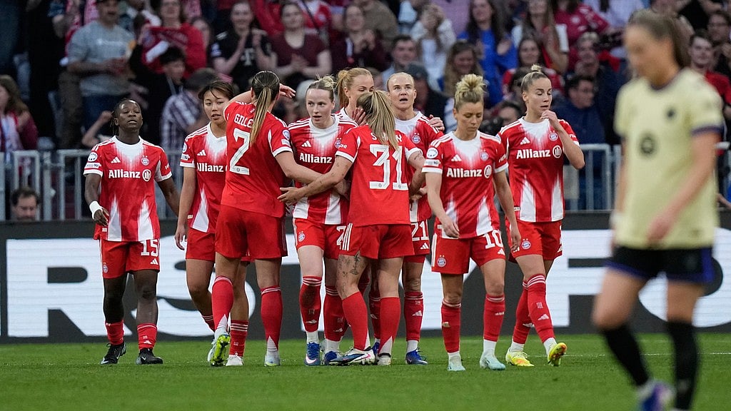 Franziska Kett, centre, celebrates after scoring her side's first goal during the Women's Champions League semi-final first-leg match between Bayern Munich and Barcelona in Munich. - AP/Matthias Schrader