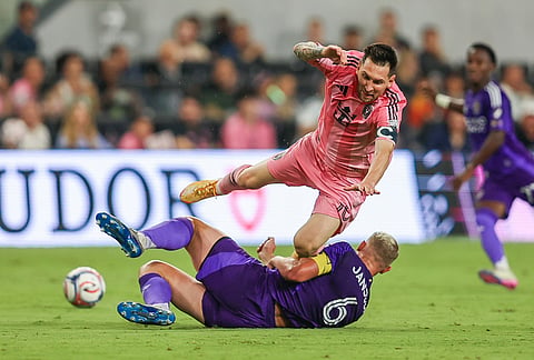 Inter Miami forward Lionel Messi (10) battles for the ball with Orlando City defender Robin Jansson (6)in the second half during an MLS soccer match, in Miami.