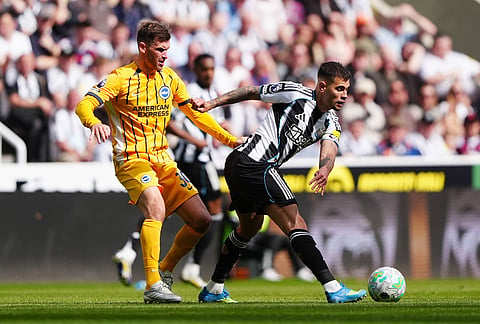 Brighton and Hove Albion's Pascal Gross, left, and Newcastle United's Bruno Guimaraes battle for the ball during their English Premier League soccer match in Newcastle, England.
