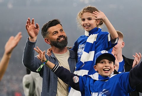 Schalke's head coach Miron Muslic celebrates with his family after FC Schalke 04 secured promotion to the German Bundesliga by winning the Bundesliga 2 match against Fortuna Duesseldorf at the Arena in Gelsenkirchen, Germany.