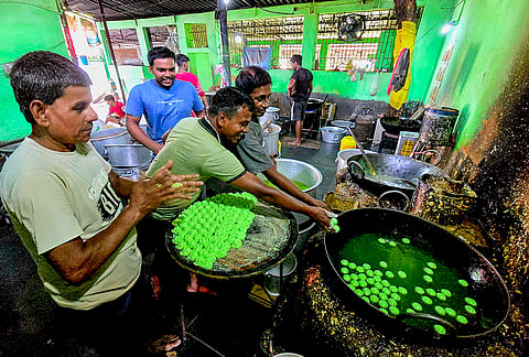 Workers prepare green mango rosogollas at a sweet factory on the eve of the declaration of West Bengal Assembly election results, in Suri, Birbhum district.