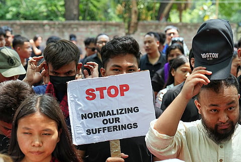 People hold placards during a protest on the third anniversary of the Manipur violence, at Jantar Mantar, in New Delhi.