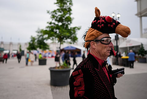 A race fan arrives before the 152nd running of the Kentucky Derby horse race at Churchill Downs, in Louisville, Kentucky. 