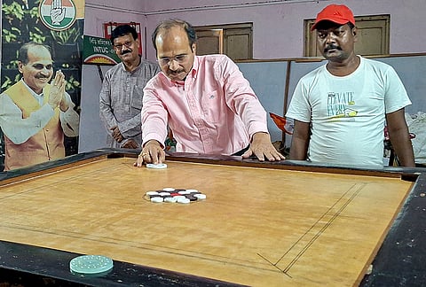 Congress leader and Baharampur Assembly candidate Adhir Ranjan Chowdhury plays carrom on the eve of vote counting, in Berhampore, Murshidabad district.