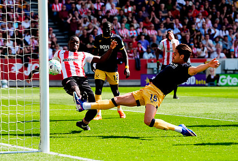 West Ham United's Konstantinos Mavropano, right, s scores an own goal to gift Brentford the lead during the English Premier League soccer match between Brentford and West Ham United, in London.