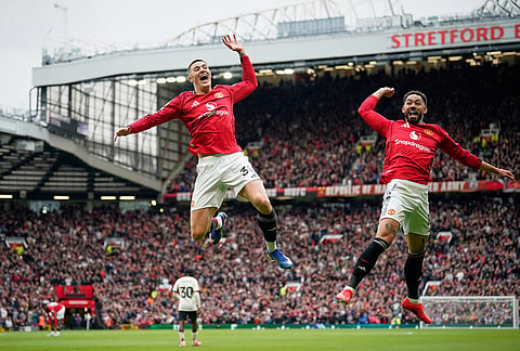 Manchester United's Benjamin Sesko, centre, celebrates with Manchester United's Matheus Cunha after scoring his side's second goal during the English Premier League soccer match between Manchester United and Liverpool in Manchester, England.