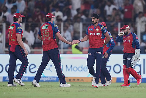 Punjab Kings' Arshdeep Singh celebrate with teammates the wicket of Gujarat Titans' Jason Holder during the Indian Premier League cricket match between Gujarat Titans and Punjab Kings in Ahmedabad.