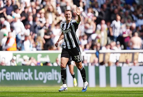 Newcastle United's Dan Burn celebrates scoring their side's second goal of the game during their English Premier League soccer match against Brighton & Hove Albion in Newcastle, England.