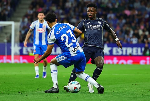 Espanyol's Omar El Hilali, left, and Real Madrid's Vinicius Junior fight for the ball during the La Liga soccer match between Espanyol and Real Madrid in Barcelona Spain.