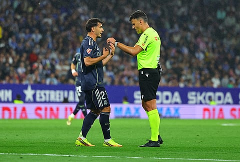 Real Madrid's Brahim Diaz argues with a referee during the La Liga soccer match between Espanyol and Real Madrid in Barcelona Spain.