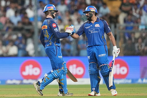 Mumbai Indians' Ryan Rickelton, left, celebrates his fifty runs with Rohit Sharma during the Indian Premier League cricket match between Mumbai Indians and Lucknow Super Giants in Mumbai, India.