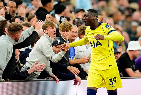 Tottenham Hotspur's Randal Kolo Muani embraces the crowd as he leaves the pitch as a substitute during the English Premier League soccer match between Aston Villa and Tottenham Hotspur in Birmingham, England.