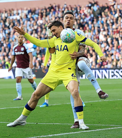 Aston Villa's Morgan Rogers, right, and Tottenham's Joao Palhinha battle for the ball during the English Premier League soccer match between Aston Villa and Tottenham Hotspur in Birmingham, England.
