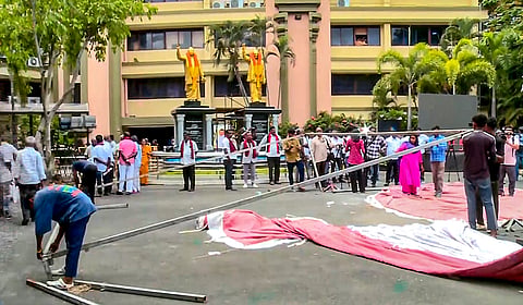 Workers remove tents and other arrangements at the DMK headquarters amid vote tabulation on the day of Assembly election results, in Chennai, Tamil Nadu.
