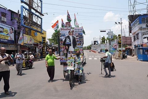 Trinamool Congress supporters carry a cut-out of Mamata Banerjee during vote tabulation on the day of assembly election results in Kolkata.