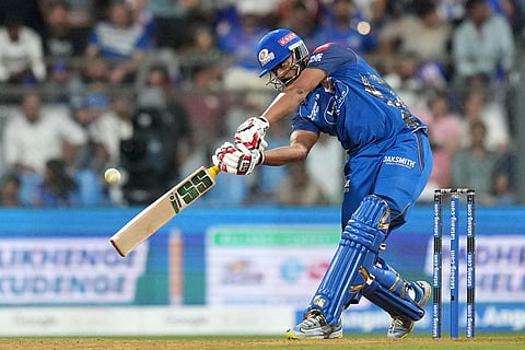 Mumbai Indians' Naman Dhir hits a six during the Indian Premier League cricket match between Mumbai Indians and Lucknow Super Giants in Mumbai, India.