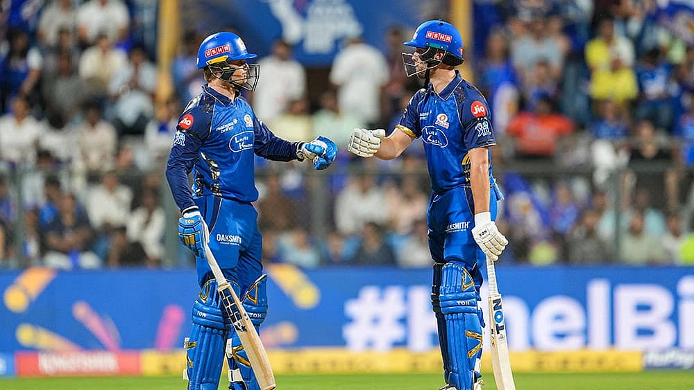 Mumbai Indians' Ryan Rickelton, left, and Will Jacks greet each other between the wickets during an Indian Premier League (IPL) 2026 T20 cricket match between Mumbai Indians and Sunrisers Hyderabad, in Mumbai, Maharashtra. - | Photo: PTI/Kunal Patil