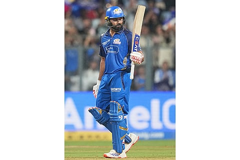 Mumbai Indians' Rohit Sharma celebrates his fifty runs during the Indian Premier League cricket match between Mumbai Indians and Lucknow Super Giants in Mumbai, India.