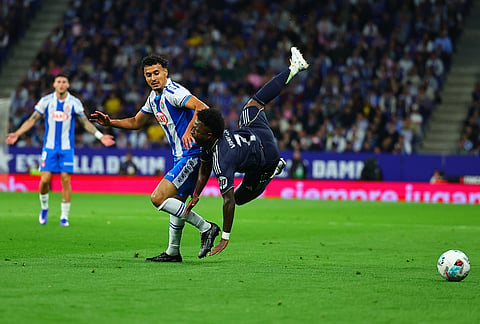 Espanyol's Omar El Hilali, left, and Real Madrid's Vinicius Junior fight for the ball during the La Liga soccer match between Espanyol and Real Madrid in Barcelona Spain.