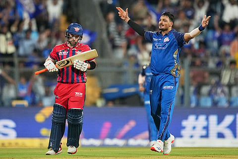 Mumbai Indians' Allah Ghazanfar, right, celebrates the wicket of Lucknow Super Giants' Josh Inglis during the Indian Premier League cricket match between Mumbai Indians and Lucknow Super Giants in Mumbai, India.