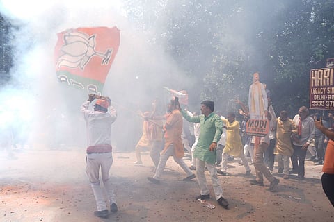 BJP supporters celebrate in BJP Delhi office.