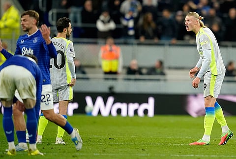 Manchester City's Erling Haaland, right, shouts in the direction of teammate Bernardo Silva during the Premier League soccer match between Manchester City and Everton in Liverpool, England.