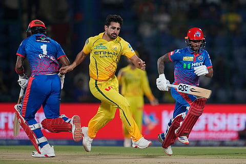Chennai Super Kings' Mukesh Choudhary chases the ball as Delhi Capitals' Pathum Nissanka and KL Rahul run between the wickets to score during the Indian Premier League cricket match between Chennai Super Kings and Delhi Capitals in New Delhi, India.