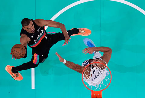 San Antonio Spurs forward Victor Wembanyama (1) drives to the basket against Minnesota Timberwolves center Rudy Gobert (27) during the first half in Game 1 of a second-round NBA playoffs basketball series in San Antonio.