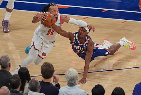 Philadelphia 76ers' Vj Edgecombe, right, fouls New York Knicks' Jalen Brunson during the first half of Game 1 in a second-round NBA basketball playoffs series in New York. 
