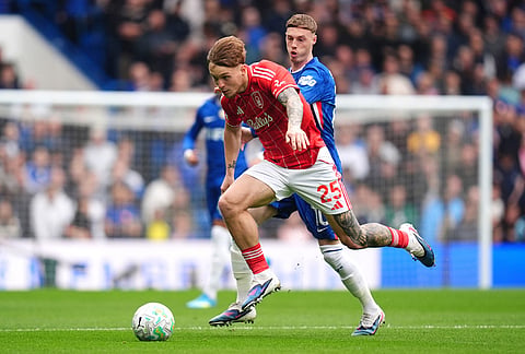 Nottingham Forest's Luca Netz, front, and Chelsea's Cole Palmer battle for the ball during the English Premier League soccer match between Chelsea and Nottingham Forest in London.