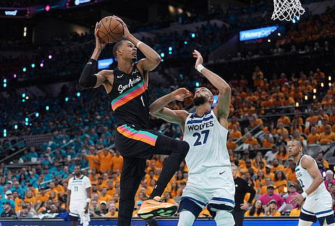 San Antonio Spurs forward Victor Wembanyama (1) works toward the basket as Minnesota Timberwolves center Rudy Gobert (27) defends during the first half in Game 1 of a second-round NBA playoffs basketball series in San Antonio.