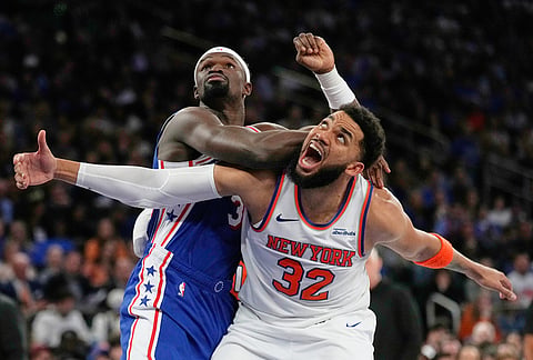 Philadelphia 76ers' Adem Bona, top, fouls New York Knicks' Karl-Anthony Towns during the second half of Game 1 in a second-round NBA basketball playoffs series in New York.