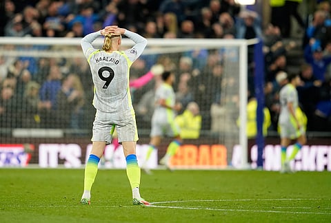 Manchester City's Erling Haaland reacts after Everton scored during the Premier League soccer match between Manchester City and Everton in Liverpool, England.