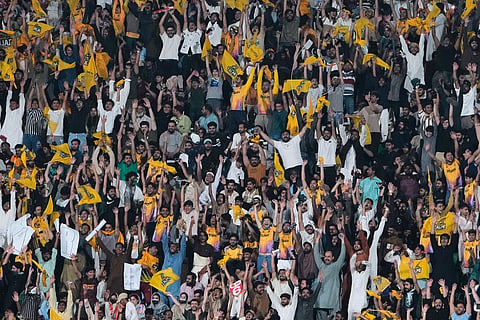 Fans cheer during the Pakistan Super League final cricket match between Peshawar Zalmi and Hyderabad Kingsmen, in Lahore, Pakistan.