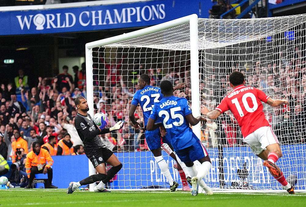 | Photo: John Walton/PA via AP : Chelsea goalkeeper Robert Sanchez, left, reacts after Nottingham Forest's Taiwo Awoniyi, center obscured, scores their side's third goal of the game during the English Premier League soccer match between Chelsea and Nottingham Forest in London.