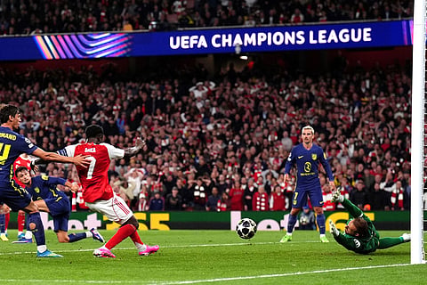 Arsenal's Bukayo Saka scores the opening goal during a Champions League semifinal, second leg, soccer match between Arsenal FC and Atletico Madrid in London.