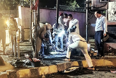 Security personnel inspect the remains of a scooter after a fire incident near the BSF headquarters, in Jalandhar, Tuesday, May 5, 2026. Locals claimed they heard a blast-like sound before the scooter caught fire, police said. 