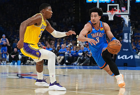 Oklahoma City Thunder guard Jared McCain (3) drives to the basket as Los Angeles Lakers' Rui Hachimura, left, defends in the second half of Game 1 in a second-round NBA basketball playoffs series in Oklahoma City.
