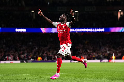 Arsenal's Bukayo Saka celebrates after scoring the opening goal during a Champions League semifinal, second leg, soccer match between Arsenal FC and Atletico Madrid in London.