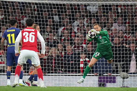 Atletico Madrid's goalkeeper Jan Oblak makes a save during a Champions League semifinal, second leg, soccer match between Arsenal FC and Atletico Madrid in London.