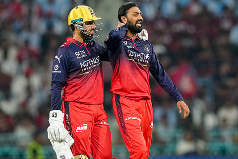 Royal Challengers Bengaluru's Krunal Pandya, right, and Jitesh Sharma during the Indian Premier League (IPL) 2026 T20 cricket match between Lucknow Super Giants and Royal Challengers Bengaluru, in Lucknow, Uttar Pradesh.