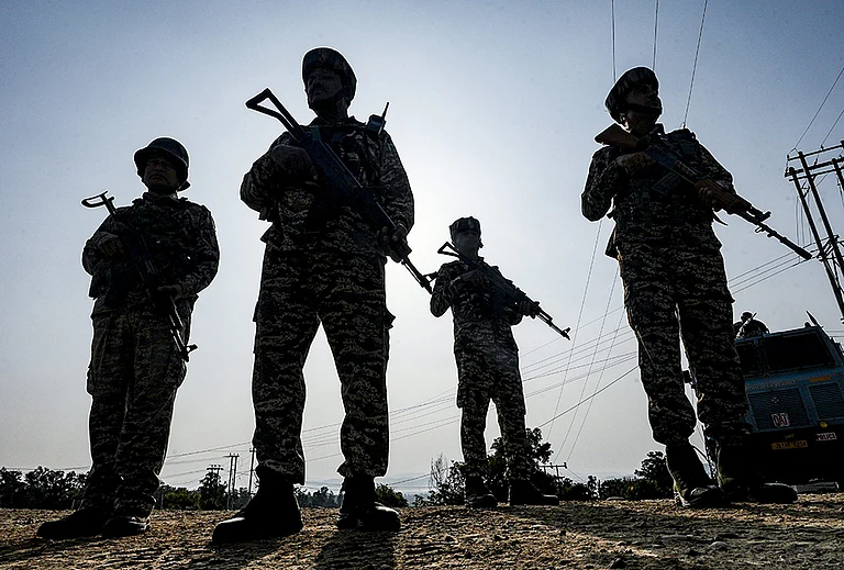 Security personnel stand guard along National Highway-44 on the anniversary of 'Operation Sindoor', in Jammu. - | Photo: PTI