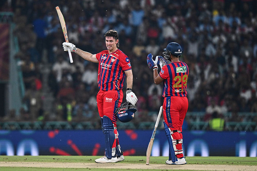 Lucknow Super Giants' Mitchell Marsh, left, celebrates his century with his batting partner Nicholas Pooran during the Indian Premier League cricket match between Royal Challengers Bengaluru and Lucknow Super Giants in Lucknow, India. - | Photo: AP