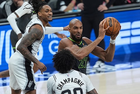 Minnesota Timberwolves center Rudy Gobert (27) drives to the basket against San Antonio Spurs forward Julian Champagnie (30) during the first half in Game 2 of a second-round NBA playoffs basketball series in San Antonio.